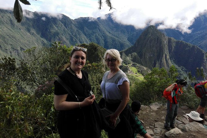 Machupicchu Guide Service - Aguas Calientes to Machu Picchu, with a guide doing the heavy lifting